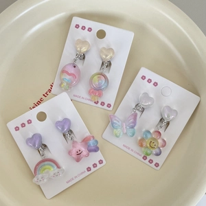 Colorful resin ear clips for girls featuring rainbow, lollipop, and flower charms