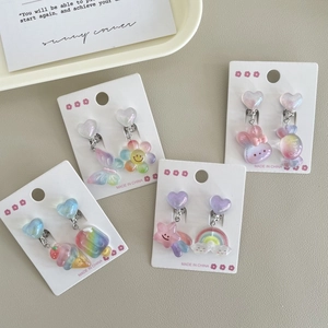 Detailed view of colorful pastel flower and heart clip-on earrings for girls with glitter