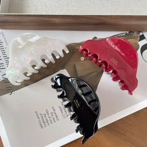 French vintage acetate hair claws in pearl white, wine red, and black with gold logo