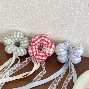 Detail of floral plaid hair scrunchies with long ribbons and delicate lace trim in three colors