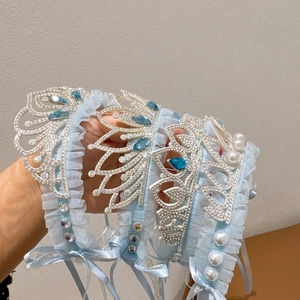 Detailed view of light blue lace princess headband with rhinestones and pearls