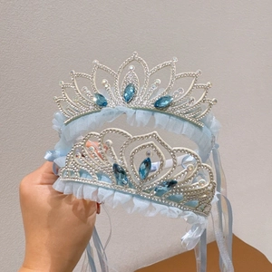 Detail of silver crown headbands with blue rhinestones and lace for girls