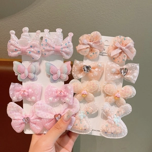Detailed set of floral and bow hair clips for kids featuring lace, pearls and glitter accents