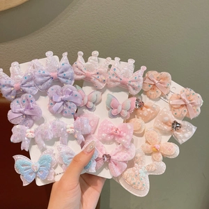 Detailed macro view of cute glitter bow hair clips for girls on display card