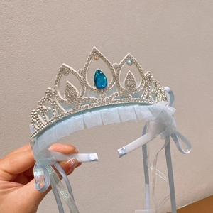 Close-up of sparkling blue rhinestone crown headband with light blue mesh and ribbon