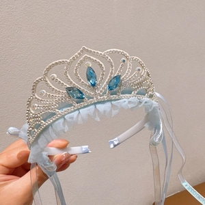 Detail of light blue lace and silver crown headband with sparkling blue rhinestones
