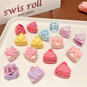 Close-up of colorful macaron-style resin hair clips in heart and flower shapes for girls