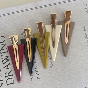 Five triangle acetate hair clips in Morandi colors with polished gold metal bases