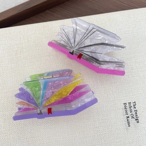 Creative book shaped acetate hair claw clips with colorful collage and bookmark detail