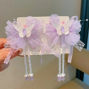 Detail of purple lace butterfly hair clips with elegant long white faux pearl tassels
