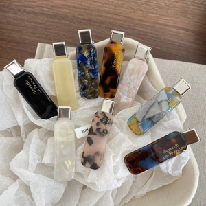 Detailed macro view of assorted French acetate hair clips in various marble patterns