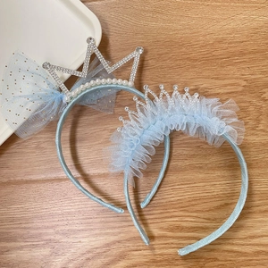Detail of light blue crown headbands with lace mesh, rhinestones and artificial pearls