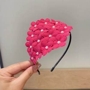 Detail of rose pink floral headband with 3D fabric flowers and white pearl centers
