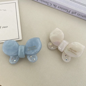 Iridescent butterfly hair clips with marble texture and rhinestones in blue and white