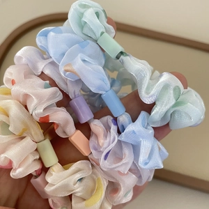 Close-up of translucent polka dot scrunchies with macaron colored plastic buckles