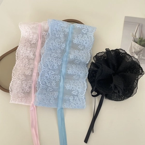 Detailed flat lay of delicate lace hair scrunchies in pink, blue, and black colors