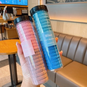 Close-up of wavy texture hair ties in transparent bottles with pink and blue colors