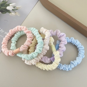 Close-up of six-piece pastel scrunchie set in assorted colors with fabric texture