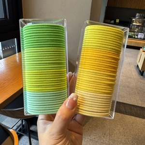 Detail view of 20pcs candy colored seamless high elastic hair ties in a transparent PVC box