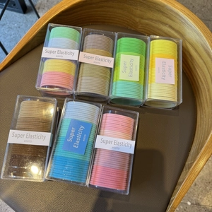 Pack of 20 high elasticity candy colored hair ties in a clear rectangular organizer box