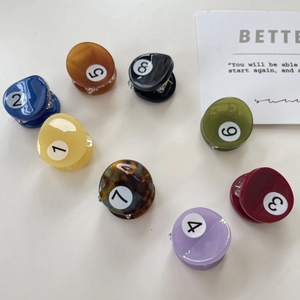 Detailed set of eight colorful billiard ball style mini hair claws with numbered designs