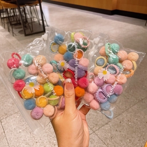 Colorful plush ball hair ties for girls in daisy patterned transparent bags