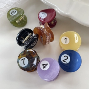 Set of eight colorful billiard-themed small acetate hair claws with numeric design