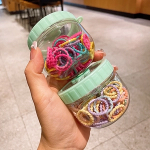 Set of two jars with colorful elastic hair ties for girls in soft macaron colors