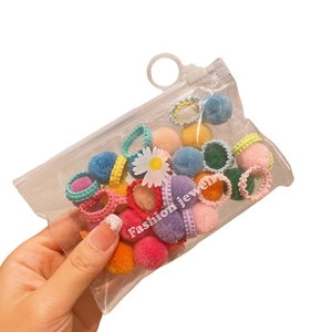 Colorful plush ball hair ties set for girls with cute daisy charms in a clear pouch