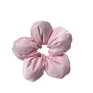 Oversized pink satin flower hair scrunchie with smooth silk-like texture for ponytails