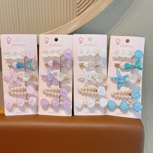 Lot de barrettes à cheveux thème marin avec étoiles de mer et coquillages en quatre couleurs