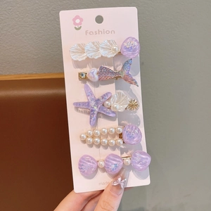 Détail du lot de 5 barrettes océan avec coquillages violets et motifs queue de poisson