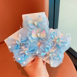 Detail of blue tulle butterfly hair clips with sequins, pearls and rhinestone droplets