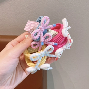Detail of colorful resin bow hair ties with heart and plaid patterns for girls