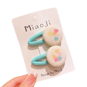 Children's mint green plaid hair clips with glitter heart design on white cards