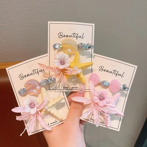 Detailed set of sea star and shell hair clips with pearls and flowers for girls