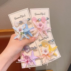 Kids ocean themed hair clip set with starfish flowers and pearls for beach vacation