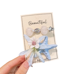Ocean style hair clips set with translucent shell and starfish floral design