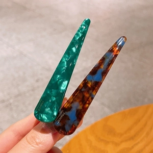 Close-up of tortoise shell and green marble pattern handmade acetate hair clips