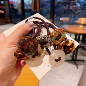 Close-up of assorted high-elasticity hair ties with acrylic leopard and marble charms