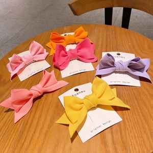 Set of six large 3D fabric bow hair clips in vibrant candy colors on display cards