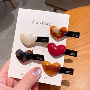 Five-piece heart-shaped acetate hair clip set in various vintage colors for women