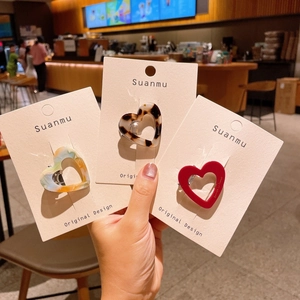 Three-piece set of heart-shaped hollow acetate hair clips in various marble patterns