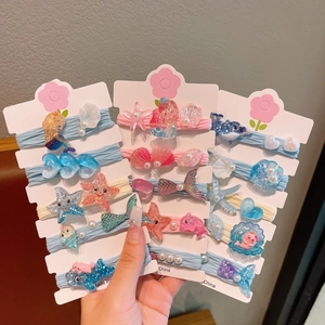 Détail des élastiques à cheveux sirène et étoile de mer sur carte en cœur