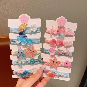 Détail de 10 élastiques à cheveux pour filles avec décorations sirène et étoile de mer