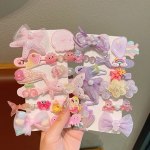 Detail of colorful children hair clips with sequins mermaid tail and star shapes