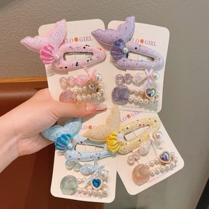 Cute ocean themed hair clips set with mermaid tails and shells on display card