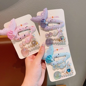 Detailed view of mermaid tail hair clips with pearls and glitter for girls set