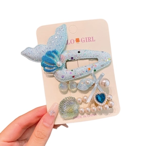 Ocean themed kids hair clips set featuring mermaid tail and shell on display card