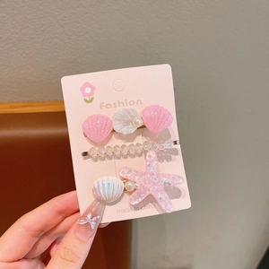 5-piece set of pink starfish and shell hair clips with pearls on a fashion card